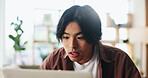 Laptop, reading and Asian man in home for remote work, news or fact check for article research. Computer, freelance journalist and person in house for editing column, story or information online