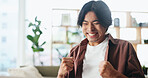 Excited, man and winning with fist pump in home for good news, project success or achievement. Happy, male person or winner with smile or accomplishment for promotion, bonus or victory in house