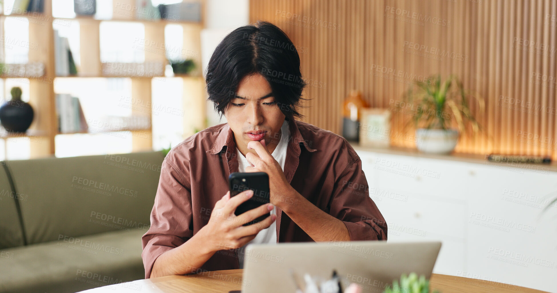 Buy stock photo Laptop, reading and asian man with phone for remote work, email notification and client project guidelines. Planning, tech and person with review instructions for task criteria, freelancer and home