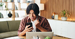 Happy man, winning and fist pump with phone in home for good news, project success or achievement. Excited, male person or smile with mobile smartphone or laptop for promotion, bonus or victory