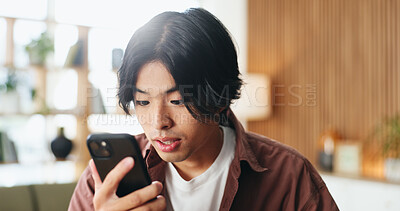 Buy stock photo Smartphone, reading and Asian man in home for blog on social media, update profile and connection. Mobile, person and check app for notification, online comment or post on internet in living room