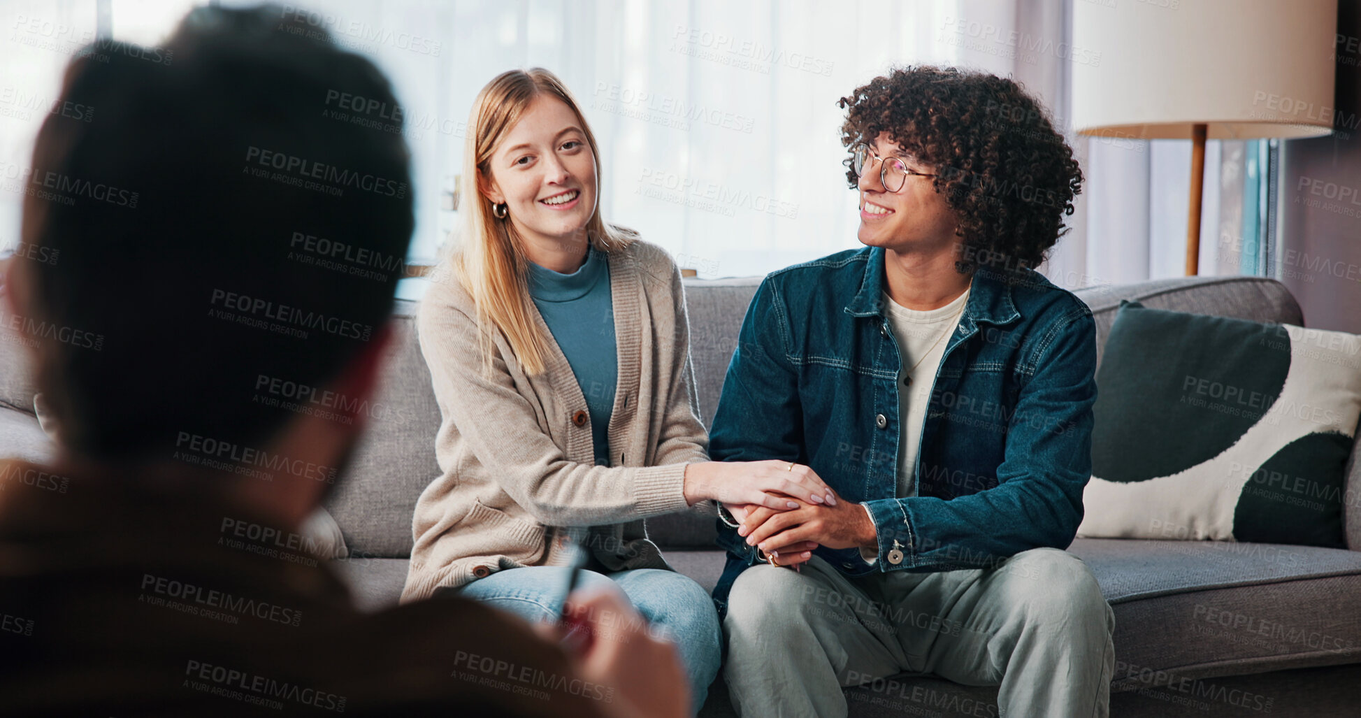 Buy stock photo Therapist, happy couple and holding hands in consultation for love, support or reconciliation. Man, woman and counseling with psychologist for advice, saved marriage or help in office with solution