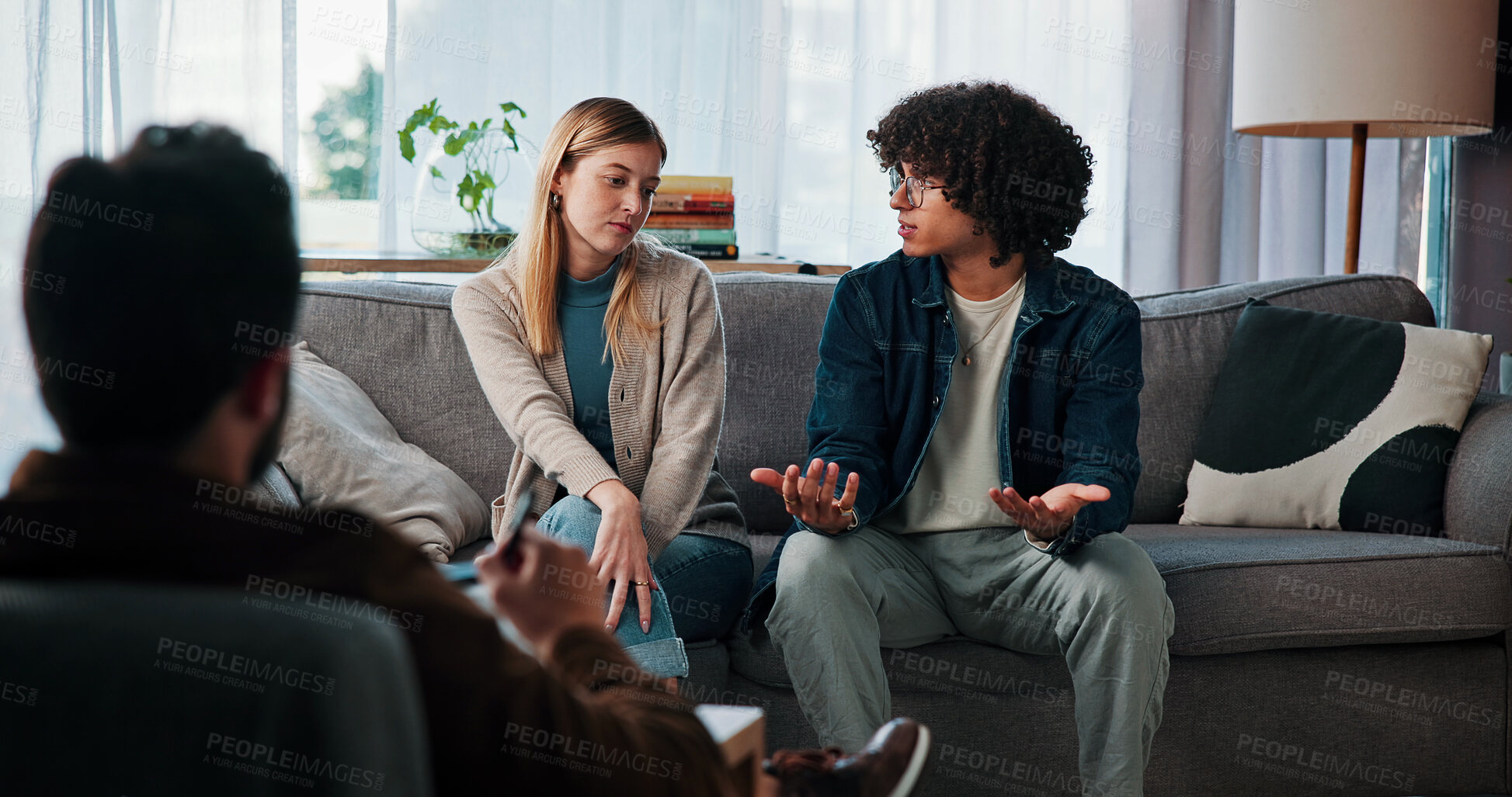 Buy stock photo Listen, couple and talking to psychologist in therapy for marriage trust, accountability and healing. Counseling, interracial people and conflict resolution with doctor for help, advice and solution