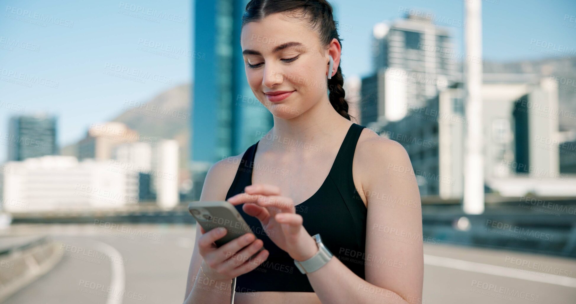 Buy stock photo Runner, phone and woman in city with earphones for music, tracking exercise and mobile app. Sports, health and person on smartphone for workout goals, fitness and active hobby with audio or playlist 