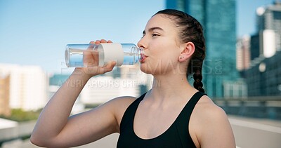 Buy stock photo Woman, fitness or drinking with water bottle for hydration, sustainability or thirst in city. Active, female person or runner with mineral liquid or beverage for break, rest or recovery in urban town