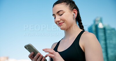 Buy stock photo Fitness, phone and happy woman in city with earphones for music, tracking exercise and mobile app. Sports, runner and person on smartphone for workout goals, active hobby and playlist for health