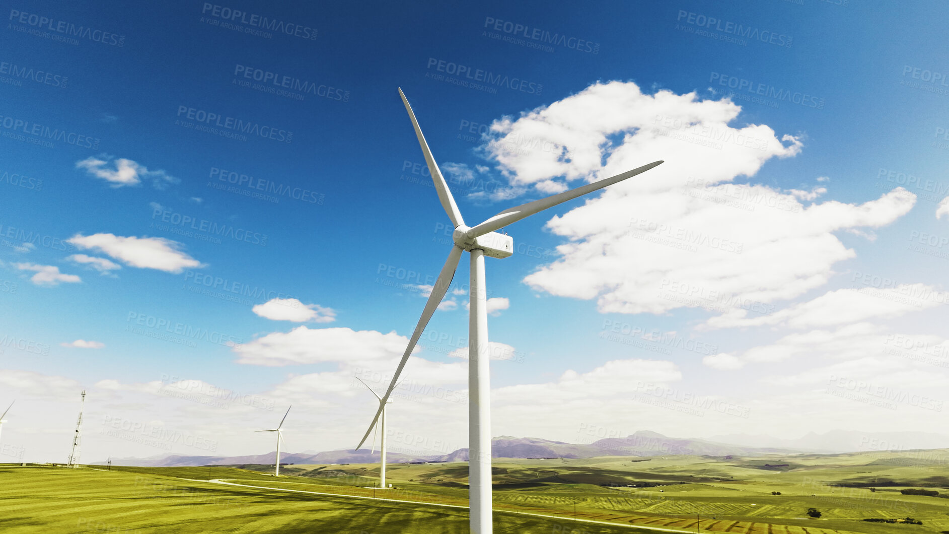 Buy stock photo Blue sky, nature and wind turbine outdoor by grass for renewable energy, sustainable or eco friendly. Field, clouds and windmill for natural resource with economic development in countryside.