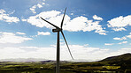 Blue sky, nature and windmill outdoor by grass for renewable energy, sustainable or eco friendly. Field, clouds and wind turbine for natural resource with economic development in countryside.