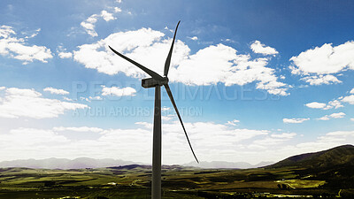 Buy stock photo Blue sky, nature and windmill outdoor by grass for renewable energy, sustainable or eco friendly. Field, clouds and wind turbine for natural resource with economic development in countryside.