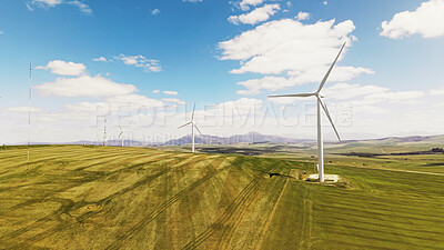 Buy stock photo Blue sky, sustainable and windmills outdoor by grass for renewable energy, nature or eco friendly. Field, clouds and wind turbines for natural resource with economic development in countryside.