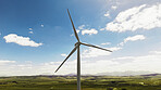 Blue sky, nature and wind turbine on farm by grass for renewable energy, sustainable or eco friendly. Field, clouds and windmill for natural resource with economic development in countryside.