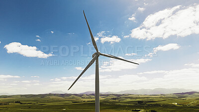 Buy stock photo Blue sky, nature and wind turbine on farm by grass for renewable energy, sustainable or eco friendly. Field, clouds and windmill for natural resource with economic development in countryside.