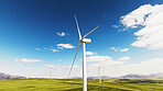 Blue sky, nature and wind turbines on farm by grass for renewable energy, sustainable or eco friendly. Field, clouds and windmills for natural resource with economic development in countryside.