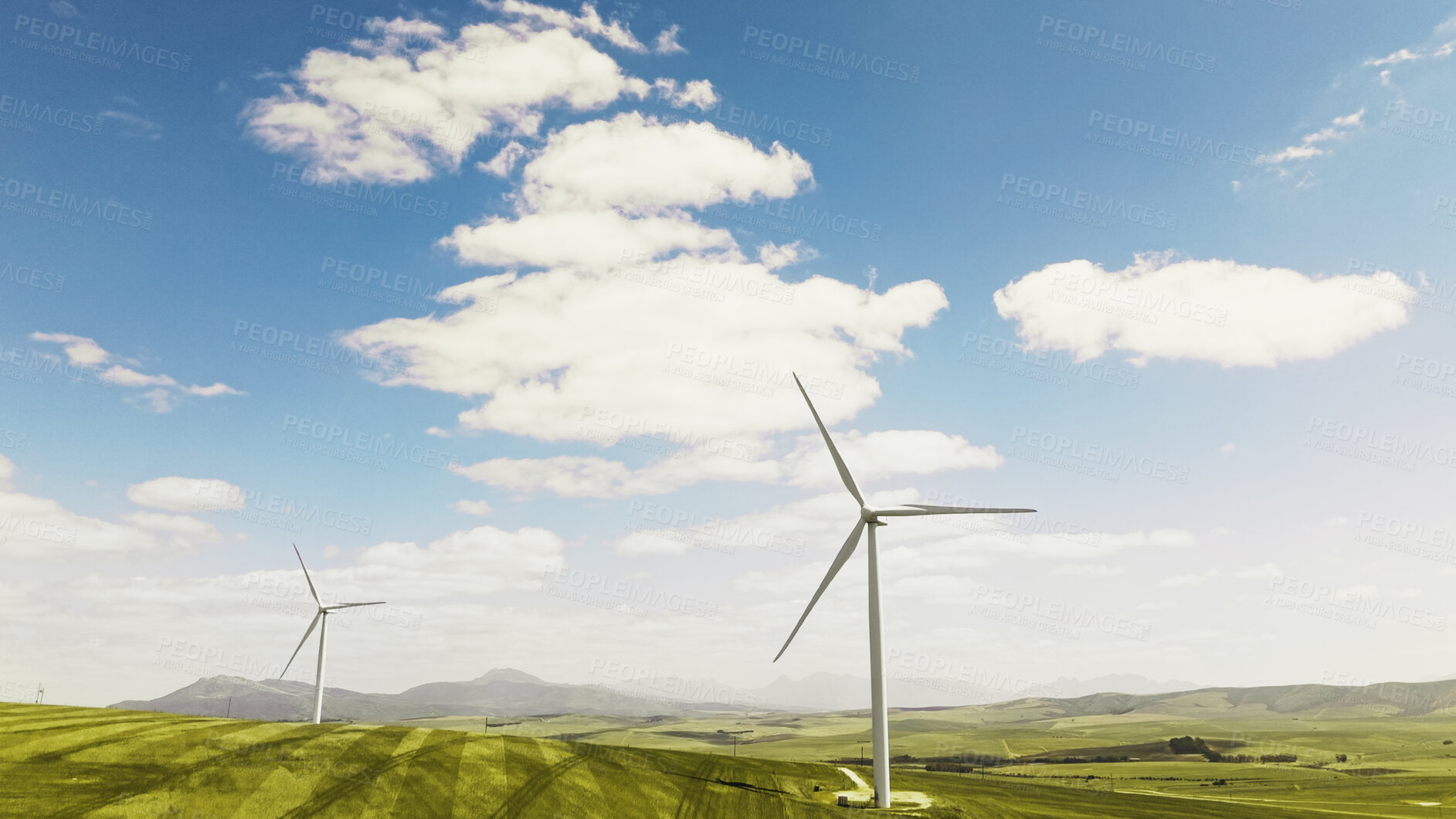 Buy stock photo Clouds, nature and wind turbine outdoor by grass for renewable energy, sustainable or eco friendly. Field, blue sky and windmill for natural resource with economic development in countryside.
