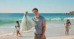 Portrait, ocean and man with trash bag, volunteer for social responsibility and sustainability. Beach, cleaning environment and person with plastic collection, waste management and community service