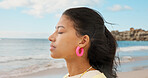 Calm, breathe and woman by beach on holiday, travel or weekend trip with peace on island. Mindfulness, relax and female person by ocean for seaside vacation on break with stress relief outdoor.