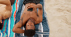 Man, relax and summer holiday at beach with phone, friends getaway and social media update for trip. Above, space and person outdoor on towel with tech, browsing website and mobile app for vacation.