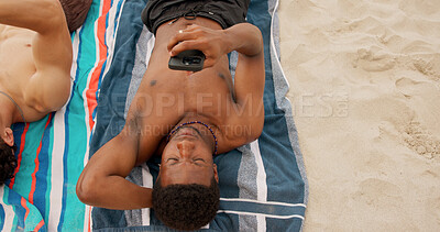 Buy stock photo Man, relax and summer holiday at beach with phone, friends getaway and social media update for trip. Above, space and person outdoor on towel with tech, browsing website and mobile app for vacation.