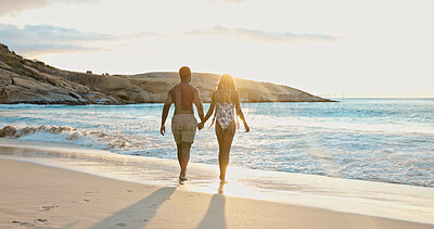 Buy stock photo Couple, holding hands and love on beach holiday, sunrise and together on summer adventure and space. Back, people and affection for partner in nature, flare and outdoor for anniversary or vacation