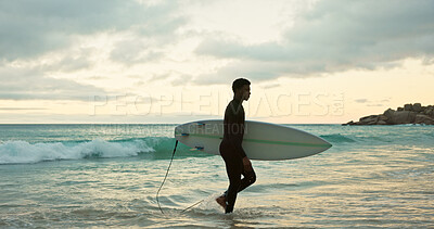Buy stock photo Beach, surfer and man with surfboard in nature, serious and thinking in morning on holiday or travel. Reflection, space and black person with surfing equipment at sea, fitness and adventure outdoor