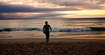 Buy stock photo Surfboard, sunset and walking with man on beach for holiday activity, sports or weekend getaway. Hobby, vacation and waves with surfer outdoor on sand at coast for fitness or training in summer