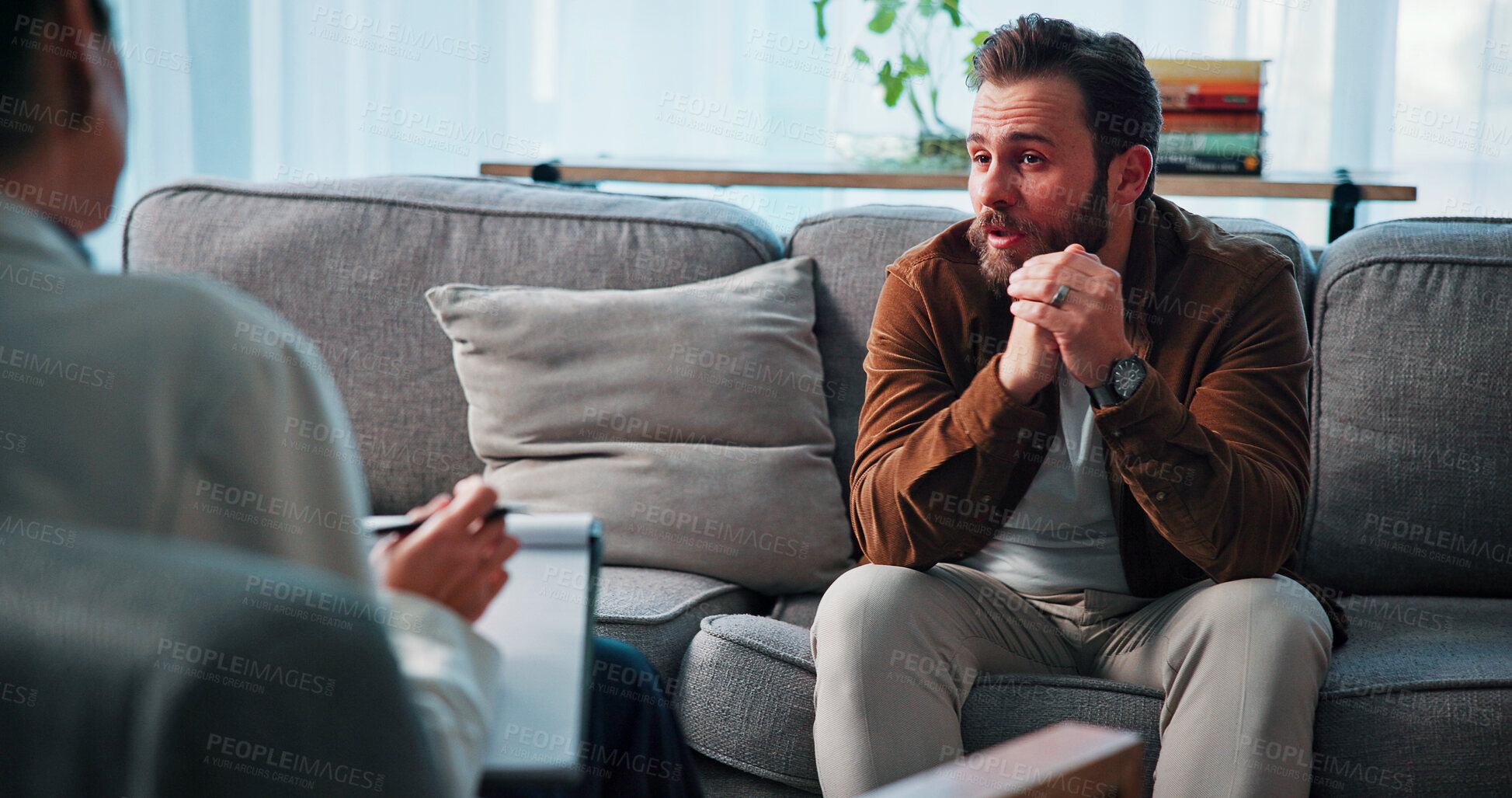 Buy stock photo Consulting, psychology and talking with people in clinic together for mental healthcare, help or support. Empathy, therapy and woman speaking to man patient in office for healing or rehabilitation