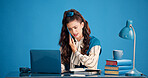 Laptop, phone call and stress with woman in studio for business discussion, feedback or negotiation. Computer, conversation and problem solving with employee person on blue background for contact