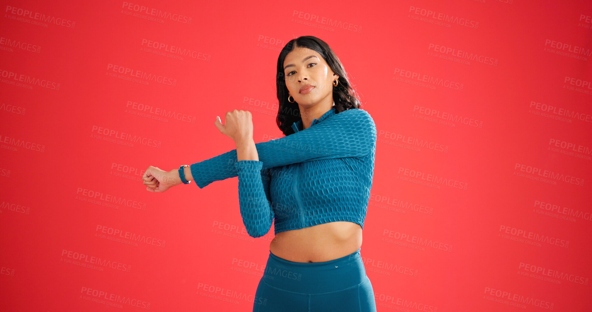 Buy stock photo Portrait, stretching and woman in studio for fitness, warm up routine and arm muscle relief activity. Start training, athlete and getting ready for workout on red background, body wellness and space