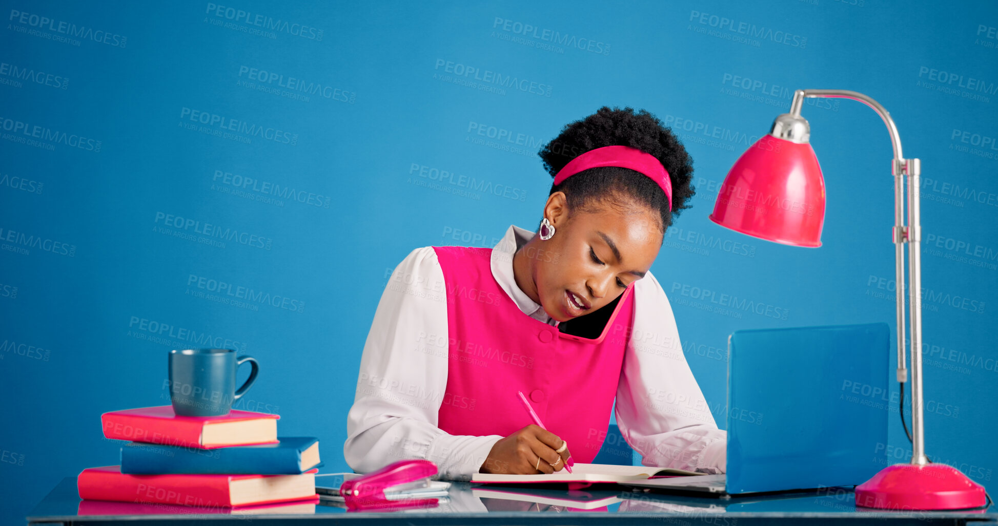 Buy stock photo Laptop, phone call and writing with black woman in studio for business feedback or negotiation. Computer, conversation and notebook with African employee person on blue background for planning