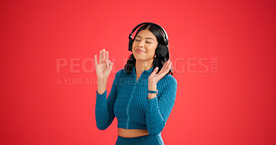 Buy stock photo Woman, fitness and dance with headphones in studio, streaming service or mockup space on red background. Girl, happy and eyes closed with audio subscription, rhythm and listen to music for exercise