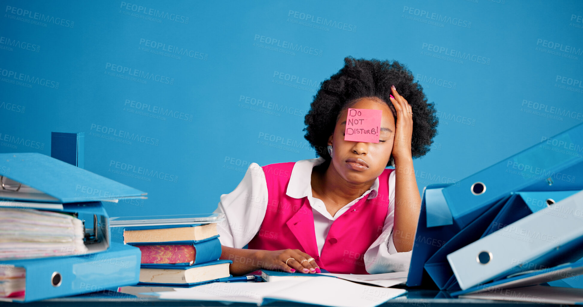 Buy stock photo Overworked, tired and black woman with sticky note in office, burnout and files for mental exhaustion. Workload pressure, fatigue and person with do not disturb sign, overwhelmed and creative studio