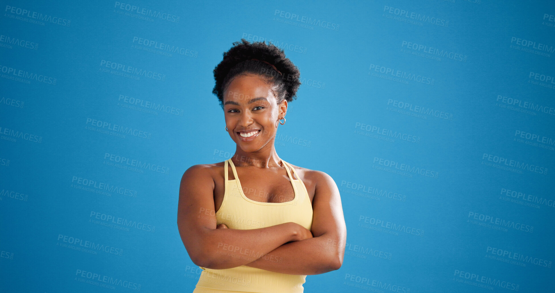 Buy stock photo Portrait, black woman or arms crossed in studio for fitness, coach or workout support for health goals. Happy, instructor or exercise guidance for body transformation, mockup space or blue background