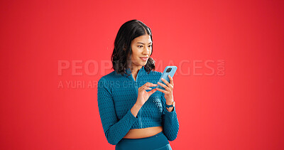 Buy stock photo Phone, fitness and woman in studio with surprise for texting, chatting or social media on mobile app. Shock, space and female person with cellphone for contact on workout plan by red background.