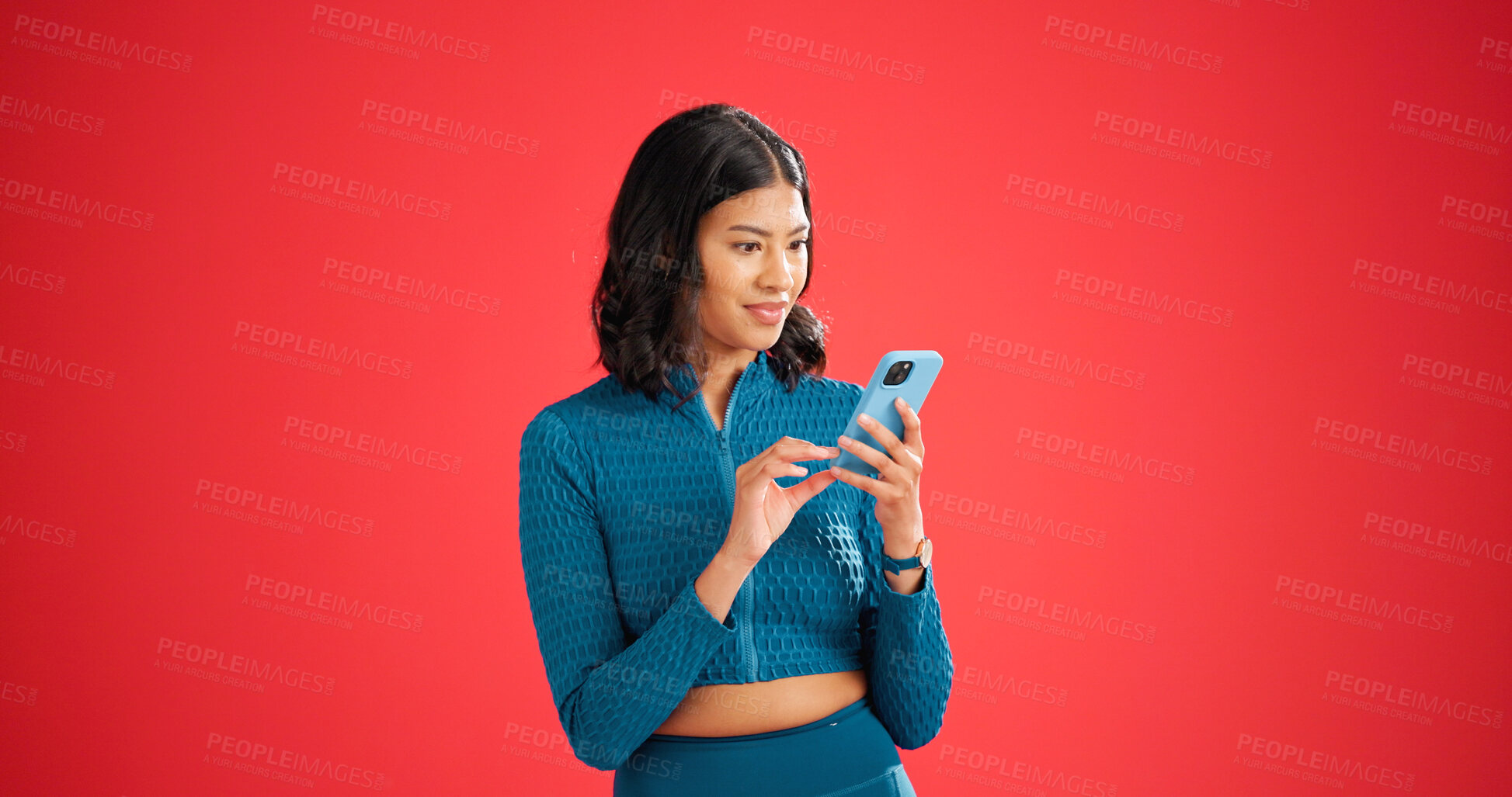 Buy stock photo Phone, fitness and woman in studio with surprise for texting, chatting or social media on mobile app. Shock, space and female person with cellphone for contact on workout plan by red background.