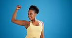 Black woman, flex and muscle in studio for fitness with laugh, smile and mockup space on blue background. African person, happy and funny face with bodybuilding, growth and show bicep for exercise