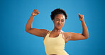 Black woman, flex and muscle in studio for exercise with pout, smile or mock up space on blue background. African person, happy and funny face with portrait, biceps and results for fitness in Kenya