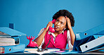 Black woman, phone call and stress with chaos at studio with thinking with space on blue background. African person, receptionist or overwhelmed with documents, admin and frustrated with telephone