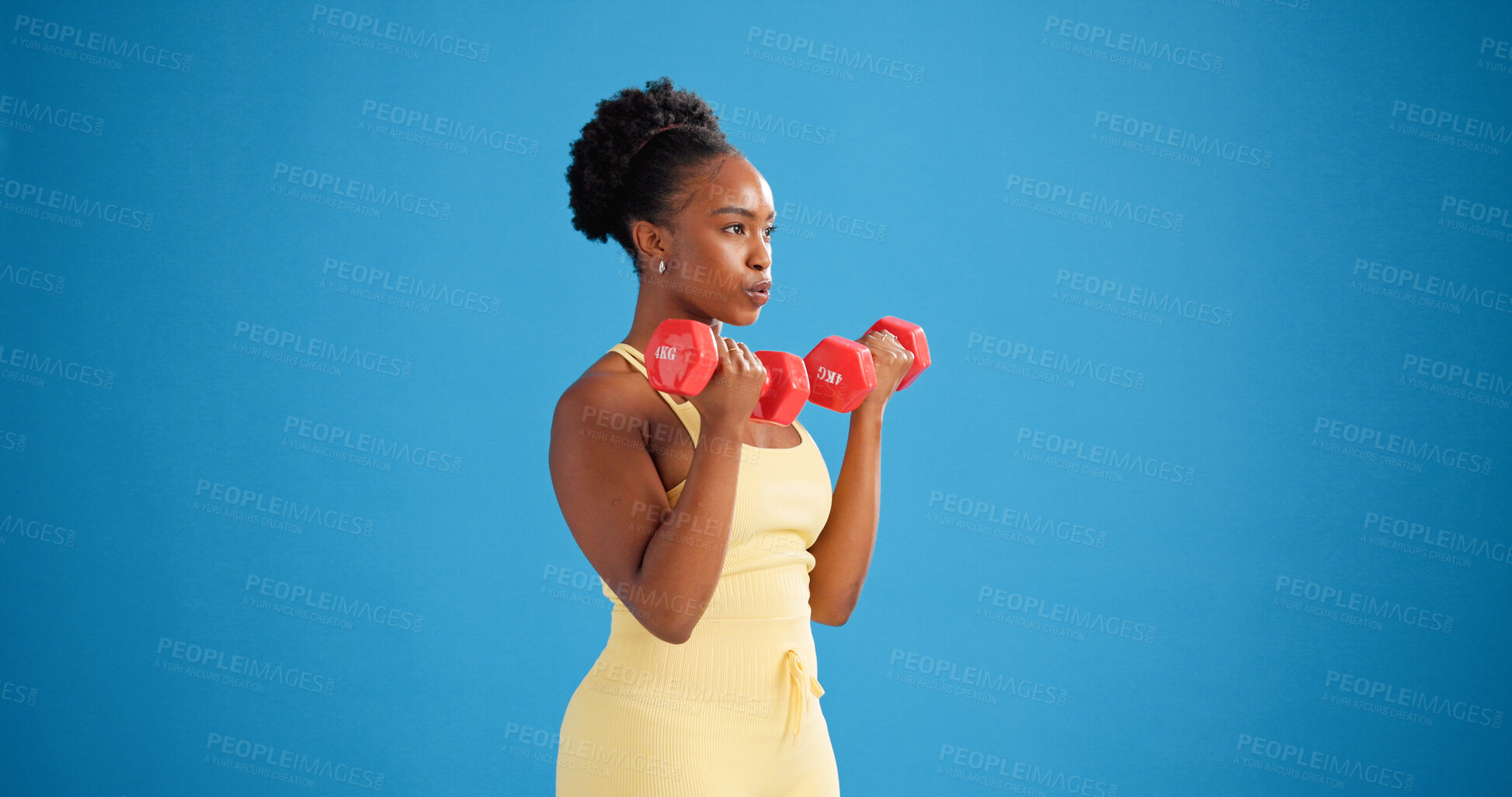 Buy stock photo Black woman, dumbbells and exercise in studio with weightlifting for strength training on blue background. African person, bodybuilder and mockup space for strong muscle, fitness or workout with gear