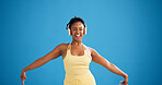 Black woman, fitness and dancing with headphones in studio, streaming or mockup space on blue background. Girl, happy and portrait with subscription, rhythm and listen to music for exercise in Kenya