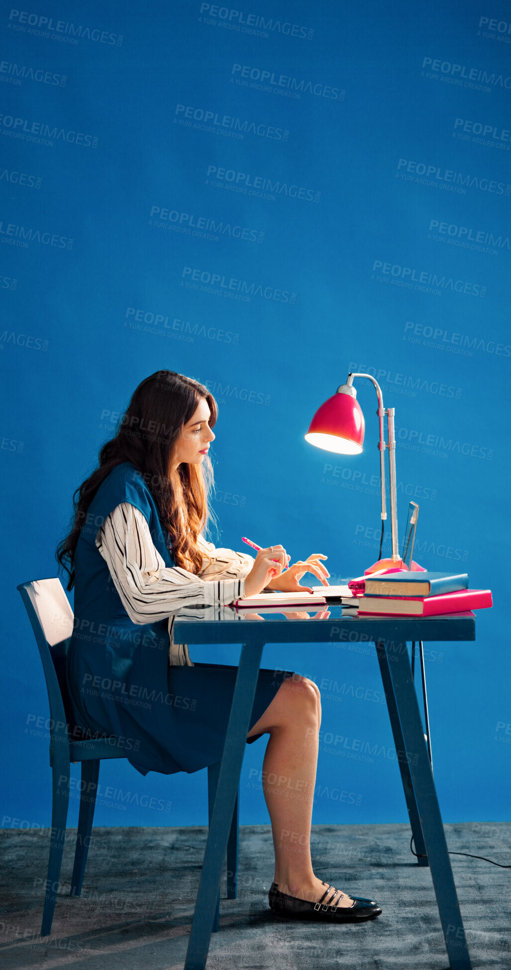 Buy stock photo Laptop, space and thinking with designer woman in studio for agenda, calendar or schedule. Computer, journal and writing with employee person on blue background for design or small business planning