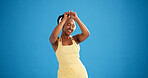 Happy woman, fitness and dancing with headphones in studio, streaming or mock up space on blue background. Girl, smile and dancer with audio subscription, rhythm and listen to music for exercise