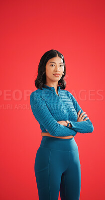 Buy stock photo Serious, athlete and woman with arms crossed in studio, portrait and pride for fitness with workout. Red background, wellness and person with confidence on space, strong and body care in Colombia