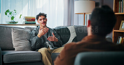 Buy stock photo Conversation, sofa and man with psychologist in office for advice, help or life coaching session. Mental health, consulting and therapist with male patient for emotional support, wellness or talking.