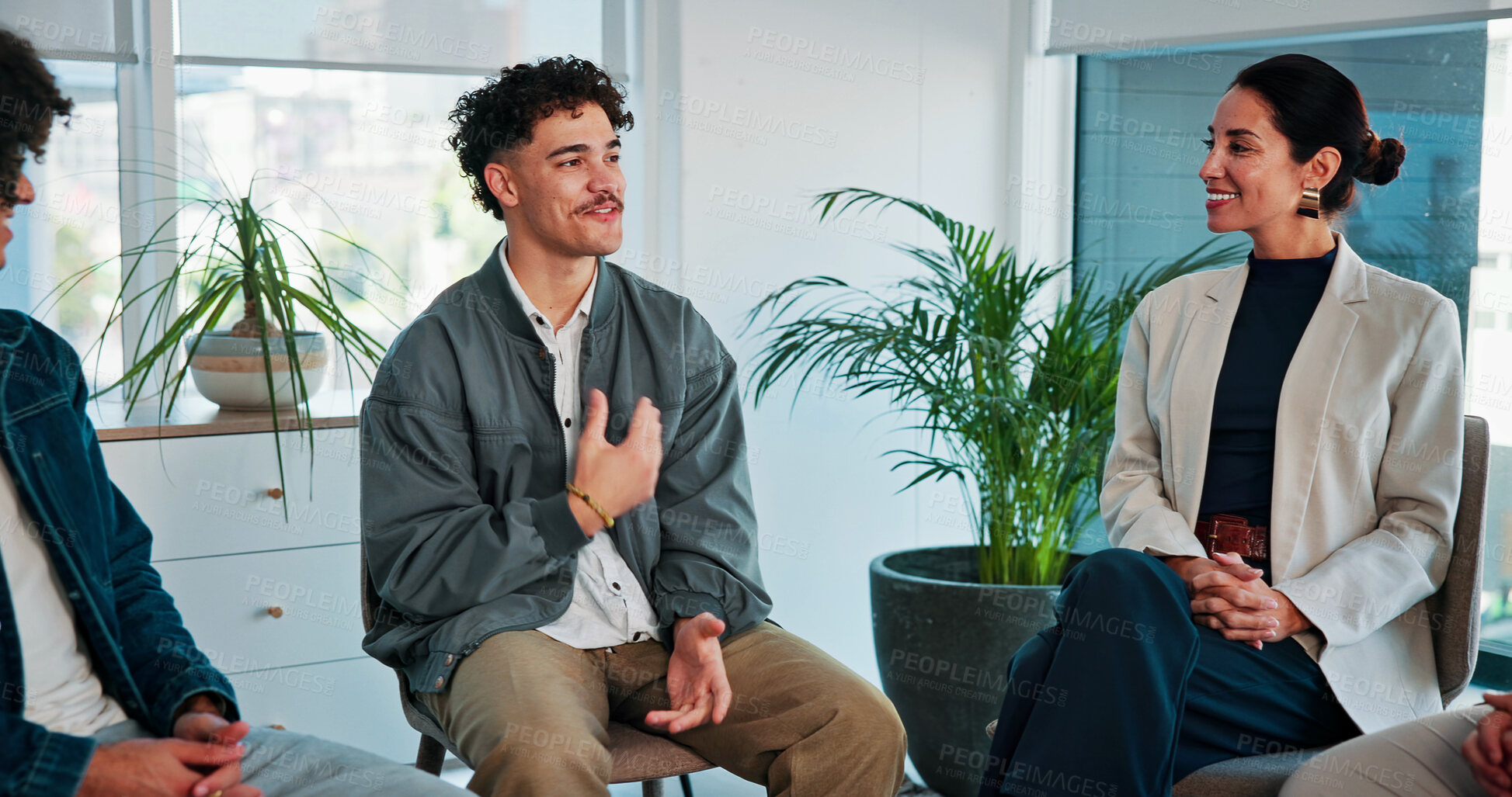 Buy stock photo Psychology, man and happy with talking in group therapy for healing, addiction recovery and support. Rehabilitation, people and male member in circle for relapse prevention, share story or counseling