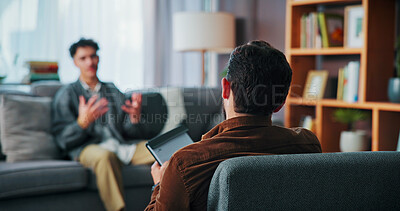 Buy stock photo Man, psychology and consultation with therapist for mental health, advice and trauma recovery. Client, therapy and counseling session with notes for assessment, listen or help with ptsd in office