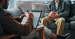 Hands, clipboard and man on sofa by psychologist for support, help or advice on mental health. Nervous, notes and male person with life coach for therapy, wellness or counseling session at clinic.