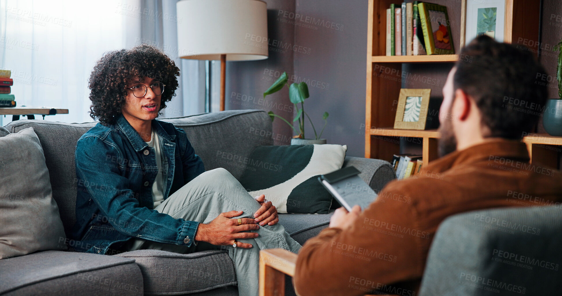 Buy stock photo Conversation, sofa and man with therapist in office for advice, help or life coaching session. Mental health, consulting and psychologist with male patient for emotional support, wellness or talking.
