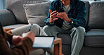 Hands, stress and man on sofa by psychologist for emotional support, help or advice on mental health. Nervous, notes and person with life coach for therapy, wellness or counseling session at clinic.
