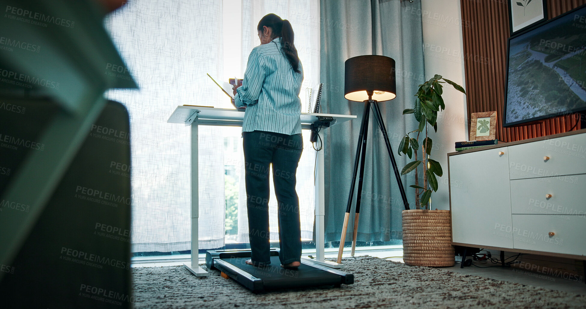 Buy stock photo Walking pad, home and back of woman for remote work, productivity and healthy habit for career. Creative, freelance and person on treadmill with laptop for research, online project and website