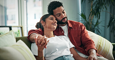 Buy stock photo Love, smile and couple relax on sofa for bonding together, holding hands and healthy relationship. Security, people and happy with affection in home for connection, weekend break and marriage loyalty